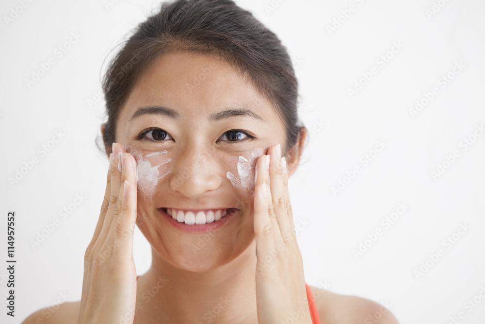 Women painted a sunscreen cream on the face Women painted a sunscreen cream on the face