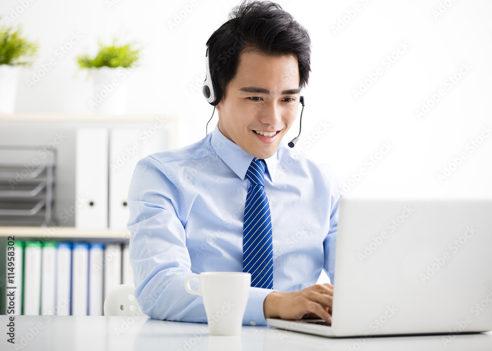 young businessman with headset working in office