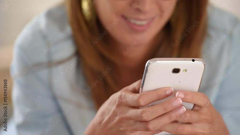 Cheerful girl having fun using smartphone Cheerful girl having fun using smartphone