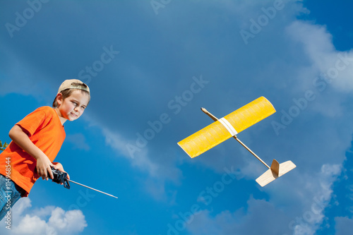 Little boy playing with handmade RC airplane toy