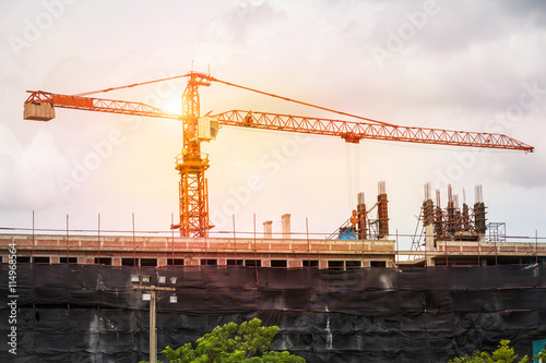 Crane working on structure building outdoor.