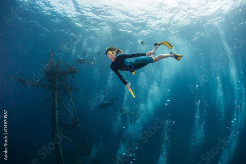 Lady the diver swims underwater