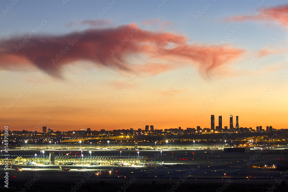 Landscape of the sunset over the city of Madrid, with city lights and clouds