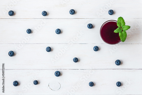 blueberry smoothie on wooden white background, top view, flat lay