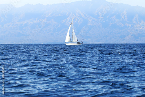 Sailing yacht in the Atlantic Ocean near the island