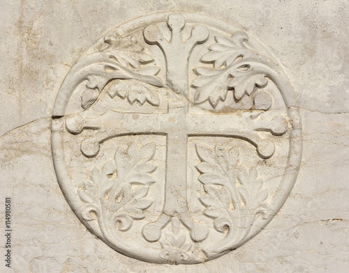 Medieval cross with leaves in Venice, from an ancient sarcophagus on St John and Paul gothic facade, in Venice