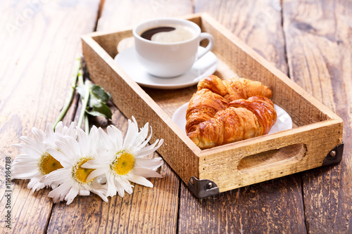 breakfast tray with croissants and coffee