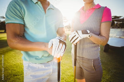 Midsection of golfer couple 