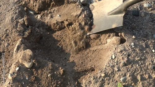 Wallpaper Mural Builder digging gravel with a shovel on sunny day Torontodigital.ca