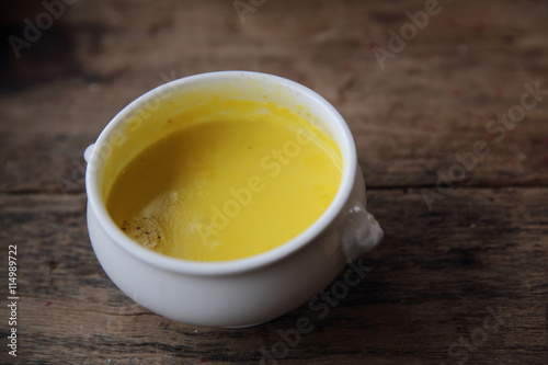 Roasted pumpkin soup on wooden background