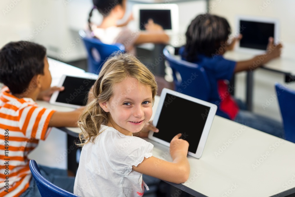 Schoolgirl with classmates using digital tablet Schoolgirl with classmates using digital tablet