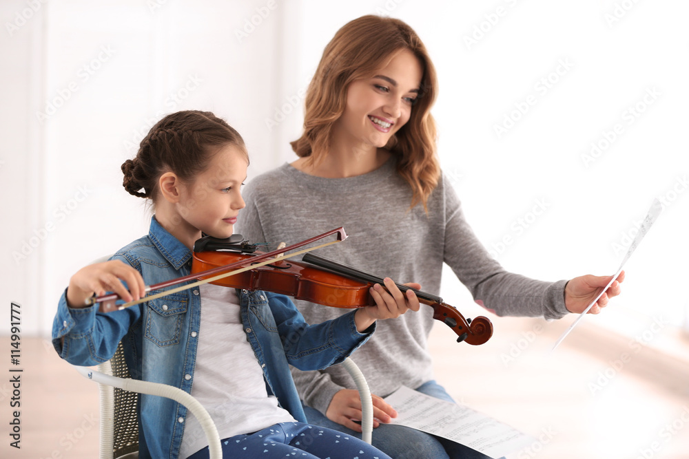 Small girl learning play violin with teacher Small girl learning play violin with teacher