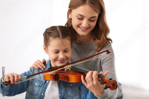 Small girl learning play vi...