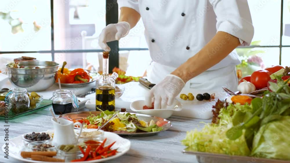 Bottle pours liquid on meat. Male hand holds a bottle. Chef adds olive oil. Bowl with piece of tuna. Bottle pours liquid on meat. Male hand holds a bottle. Chef adds olive oil. Bowl with piece of tuna.