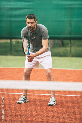 Practicing tennis. © gstockstudio