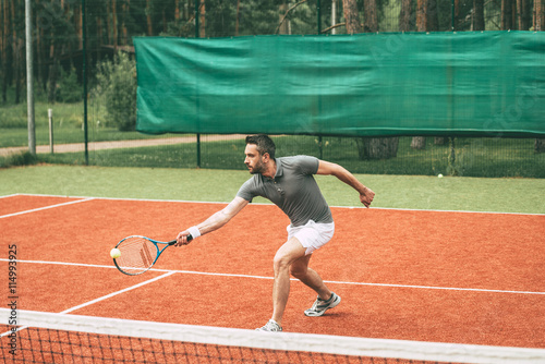 Playing tennis.  © gstockstudio
