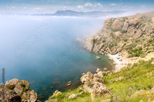 foggy rocks over sea