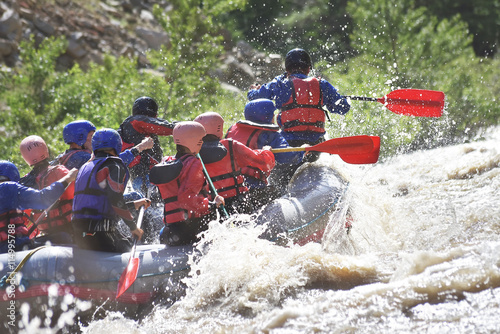 Rafting team splashing the waves