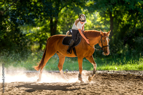 Fotografia Girl riding a horse