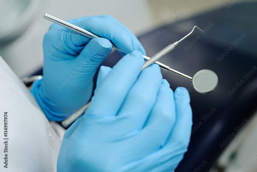 close-up of dentist hand with dental tools close-up of dentist hand with dental tools