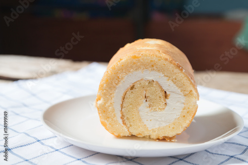Cake roll on a white plate.
