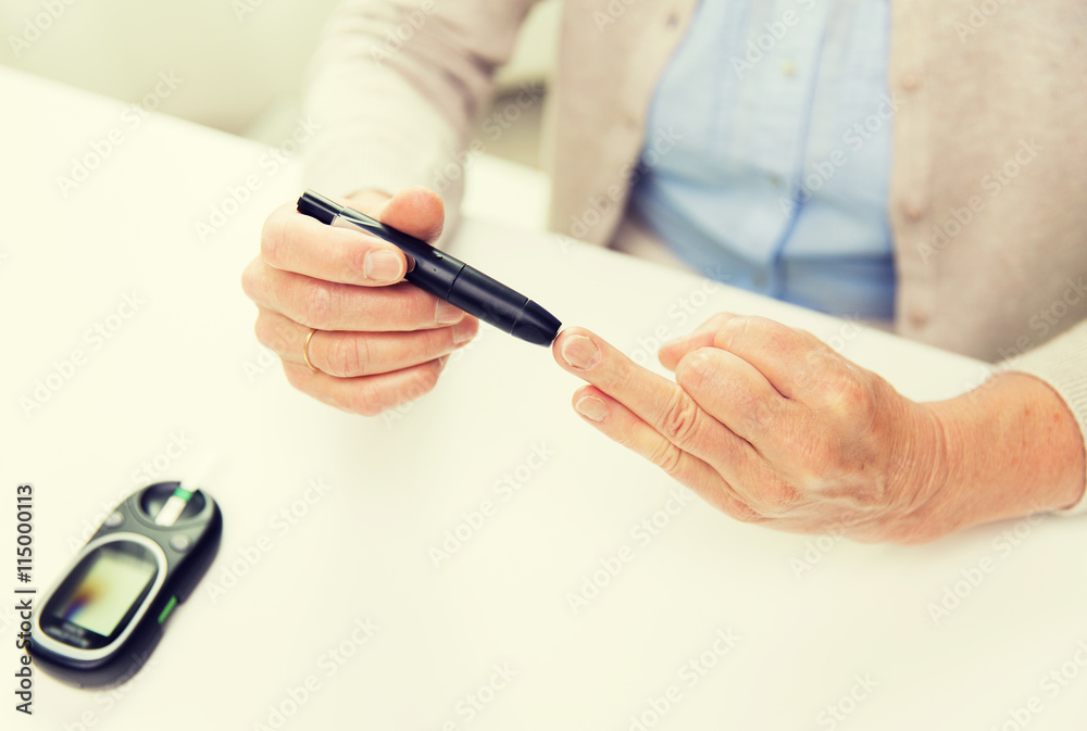 senior woman with glucometer checking blood sugar senior woman with glucometer checking blood sugar