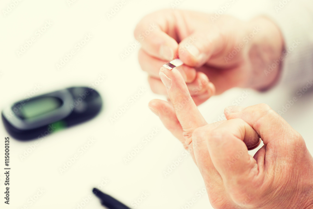 senior woman with glucometer checking blood sugar senior woman with glucometer checking blood sugar