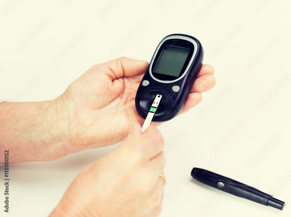 senior woman with glucometer checking blood sugar senior woman with glucometer checking blood sugar