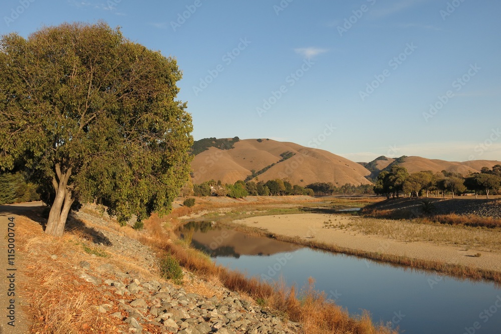 Northern California golden hills reflected in Alameda Creek, Fremont, California