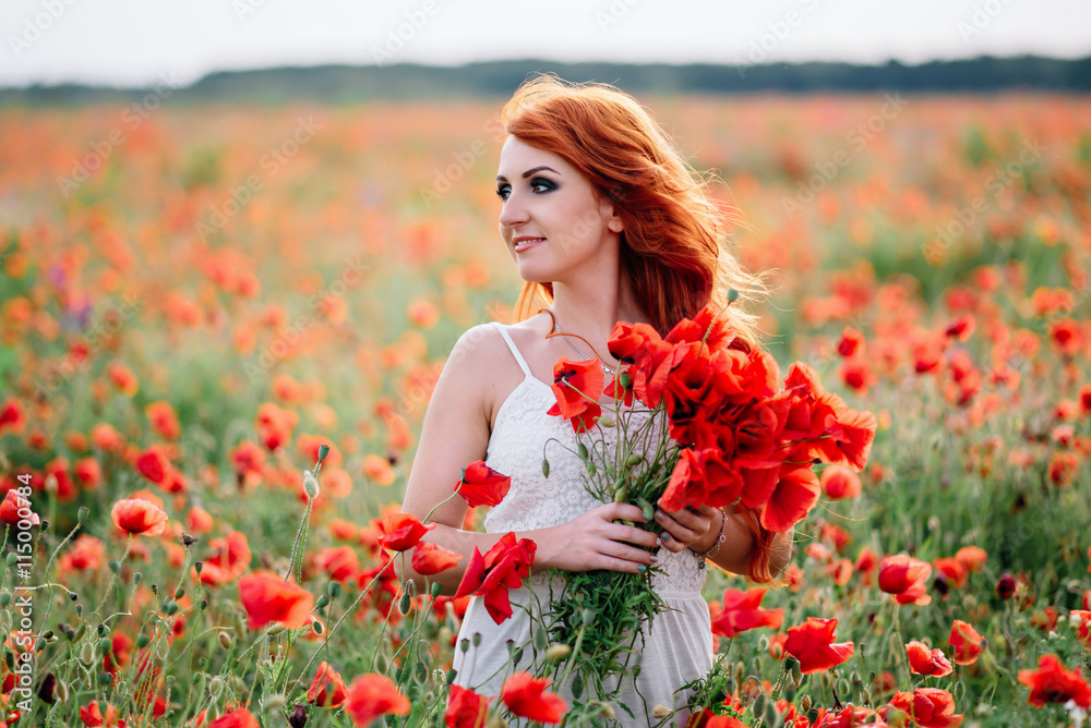 beautiful young red-haired woman in poppy field holding a bouquet of poppies beautiful young red-haired woman in poppy field holding a bouquet of poppies