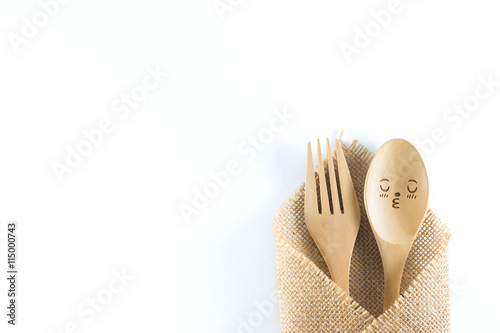 Top view of wooden spoon and fork isolated on white background