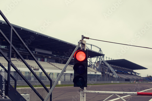 red traffic lights and road sign on race track