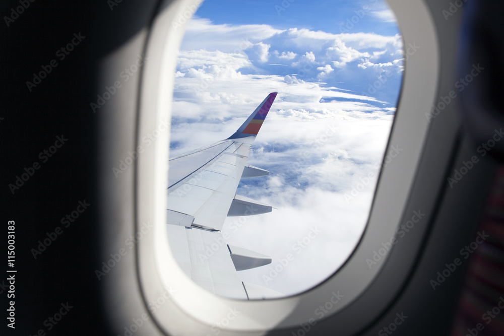 Airplane wing out of window and beautiful cloud Airplane wing out of window and beautiful cloud