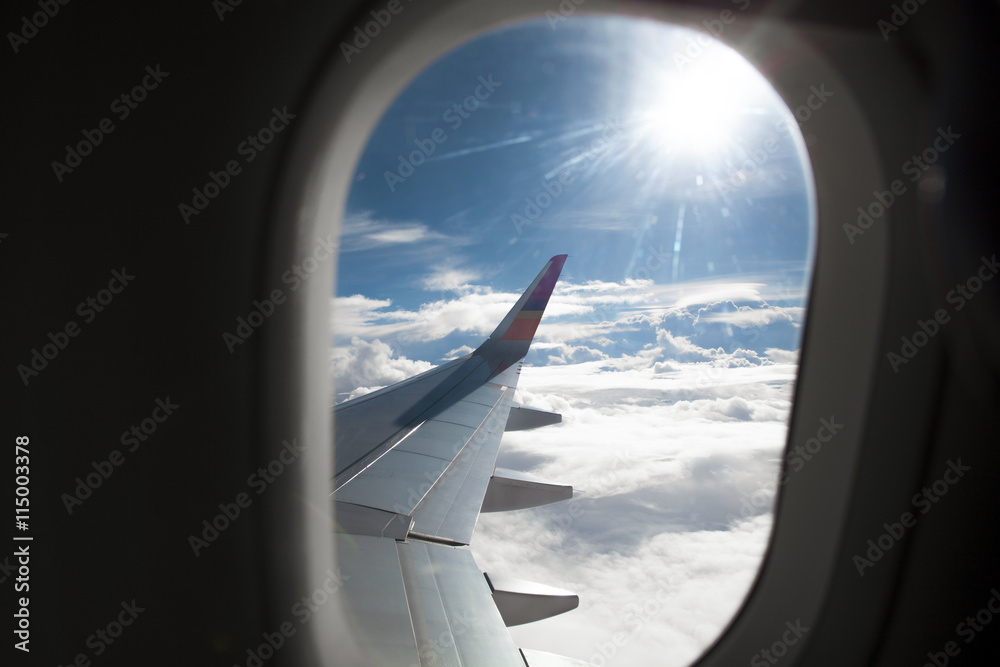 Airplane wing out of window and beautiful cloud Airplane wing out of window and beautiful cloud