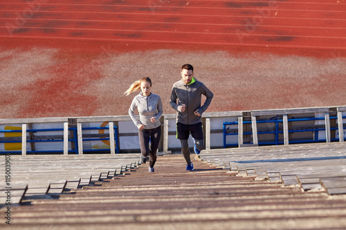 couple running upstairs on stadium