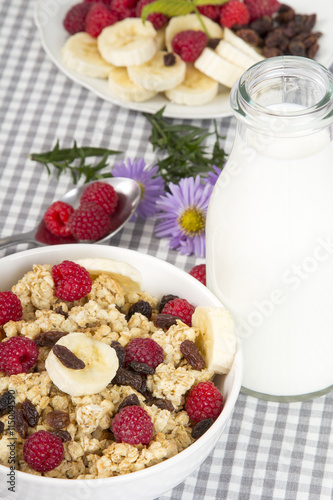granola with fruits and bottle of fresh milk 