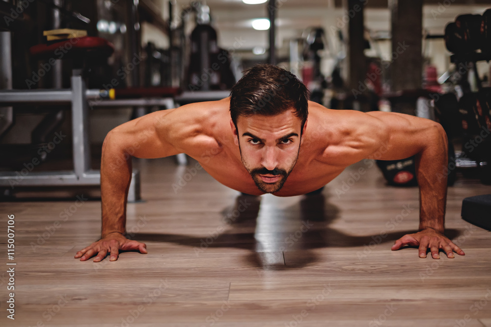Man doing push ups and looking in front of him Man doing push ups and looking in front of him