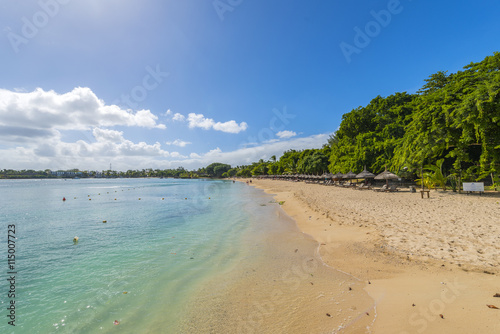 Fototapeta Naklejka Na Ścianę i Meble -  Mauritius beach umbrellas, thatch. Tropical Mauritius island water & beach resort, Turtle Bay - Balaclava