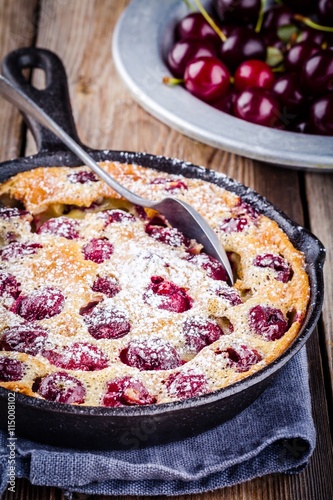 Clafoutis cherry pie on  wooden background photo