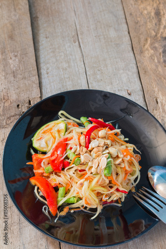 Green Papaya Salad (Som tum Thai) on wood table,Thai food
