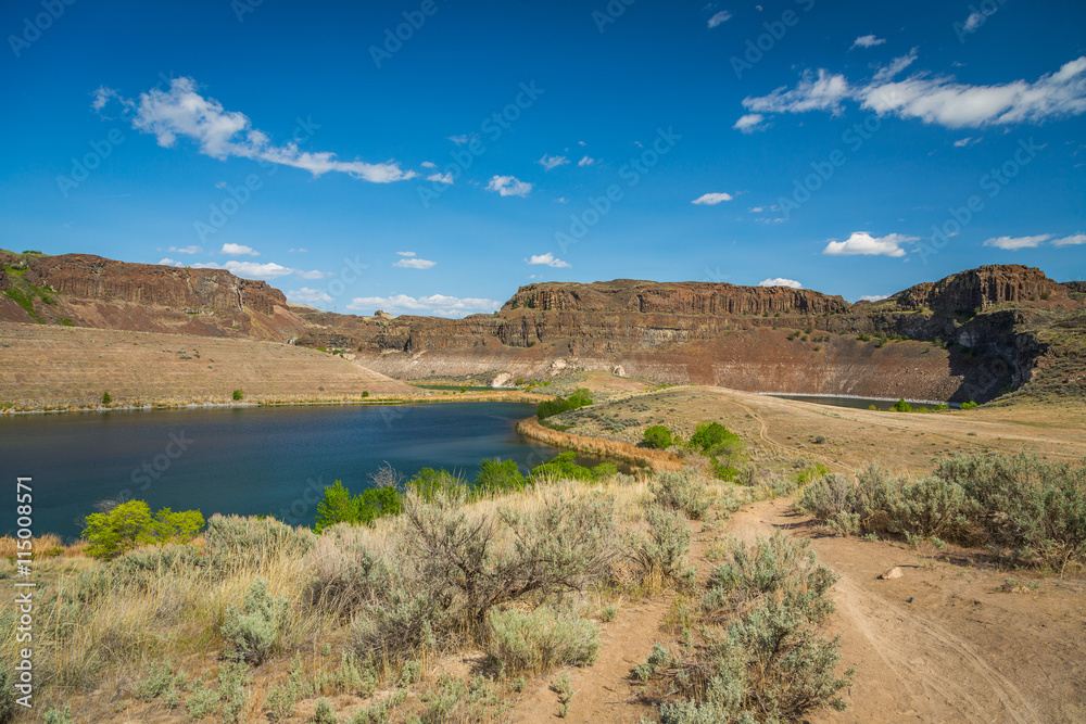 Lake in the rocks. Dry plants on the lake. Ancient Lakes trail, Eastern Washington, Spring Lake in the rocks. Dry plants on the lake. Ancient Lakes trail, Eastern Washington, Spring