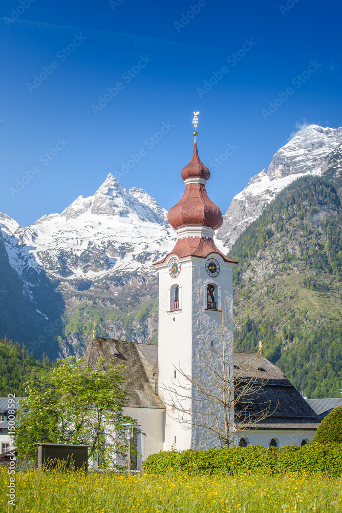 Church of Lofer in front of snowy Loferer Steinberge, Salzburger Land, Austria
