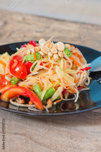 Green Papaya Salad (Som tum Thai) on wood table,Thai food