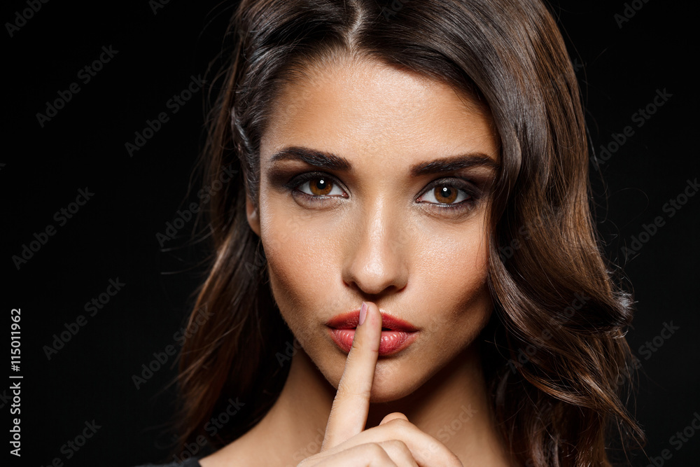 Portrait of beautiful girl in black dress over dark background Portrait of beautiful girl in black dress over dark background