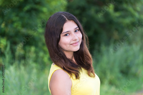 Portrait of girl with dark hair on the nature