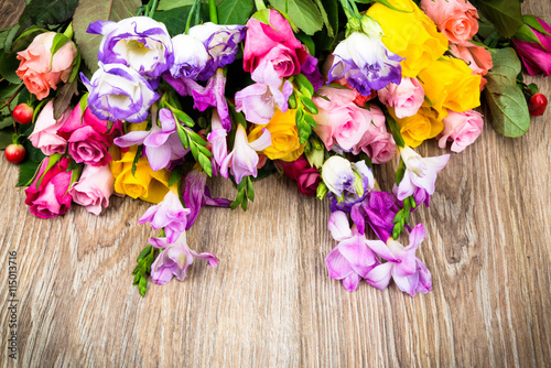 Mixed flowers on wooden background