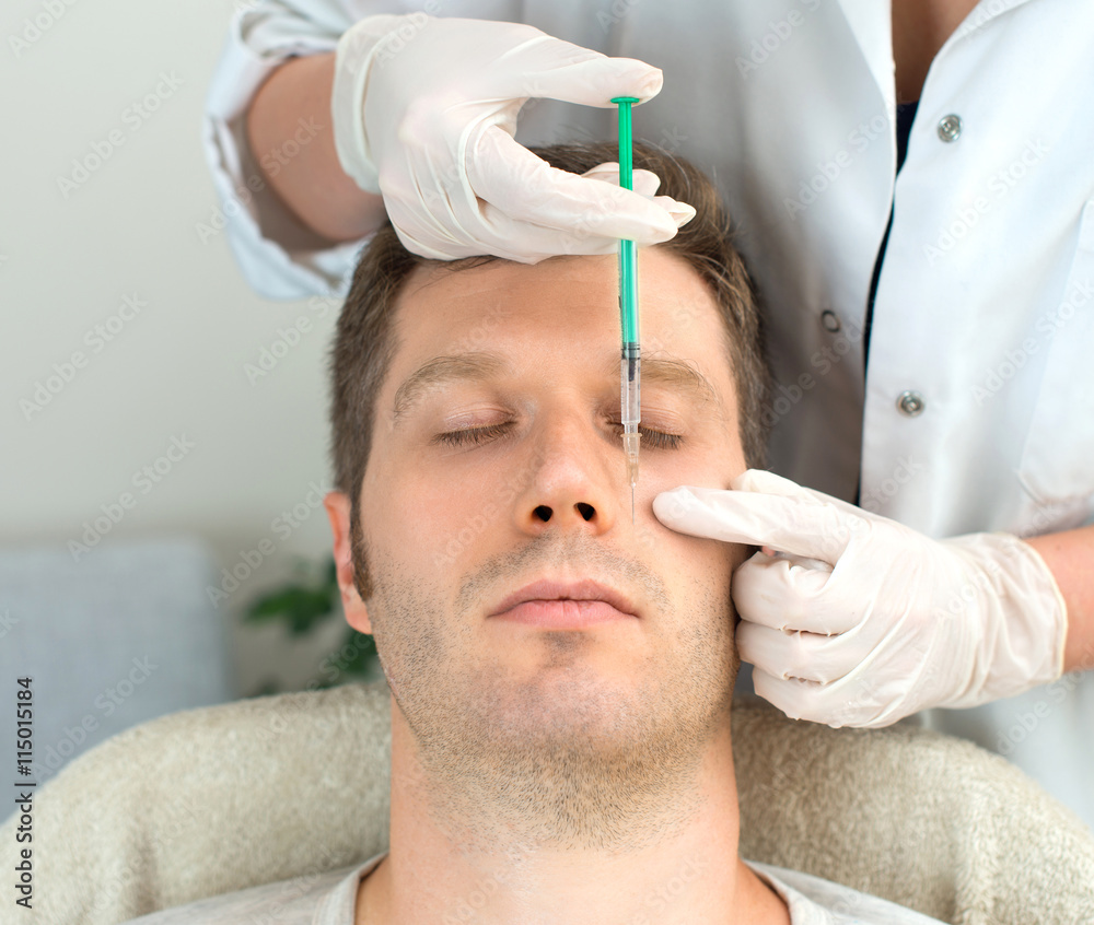 Handsome man is getting injection. Concept of aesthetic beauty. Handsome man is getting injection. Concept of aesthetic beauty.
