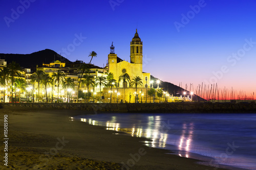 Sunset view of church at beach. Sitges