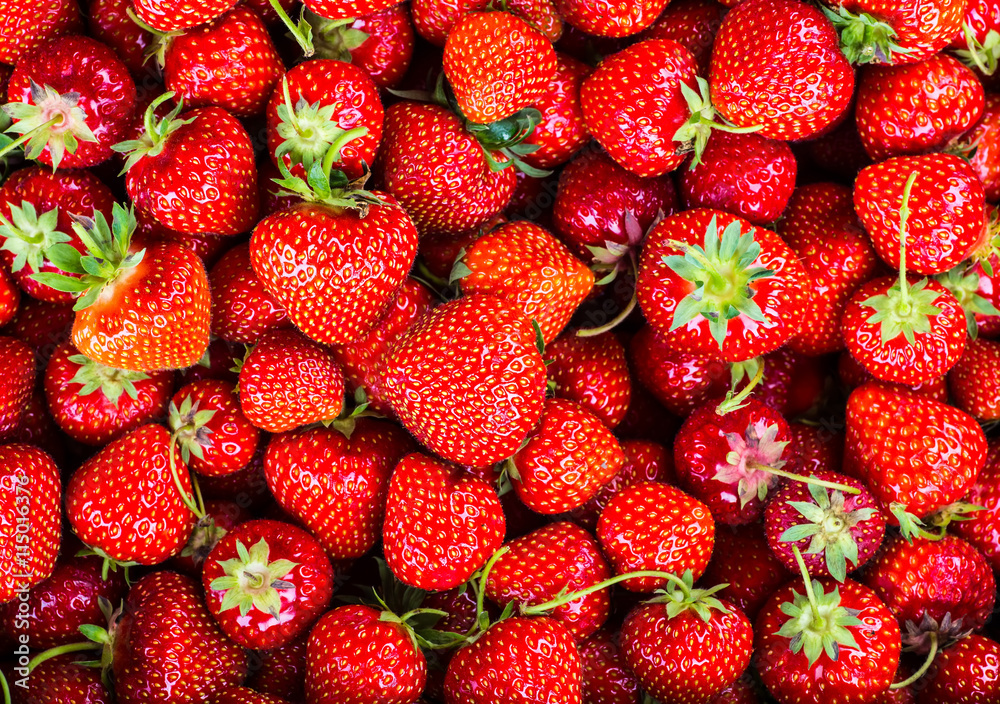 Strawberry on wood background. Strawberry with green leaves. Strawberry on wood background. Strawberry with green leaves.
