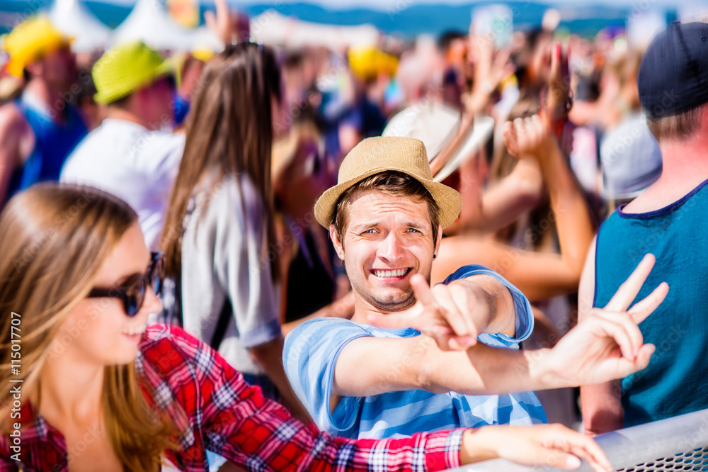 Fototapeta premium Teenagers at summer music festival enjoying themselves